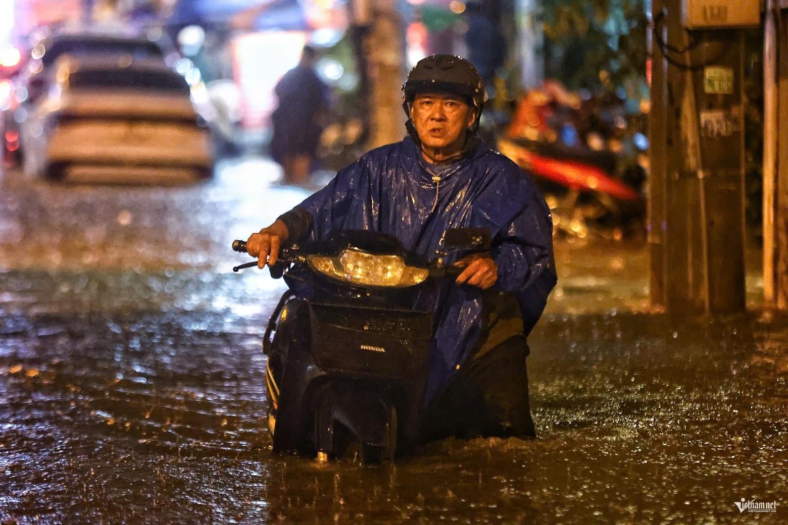 Nước chảy xiết cuốn trôi xe máy, người dân TPHCM lao vào giải cứu